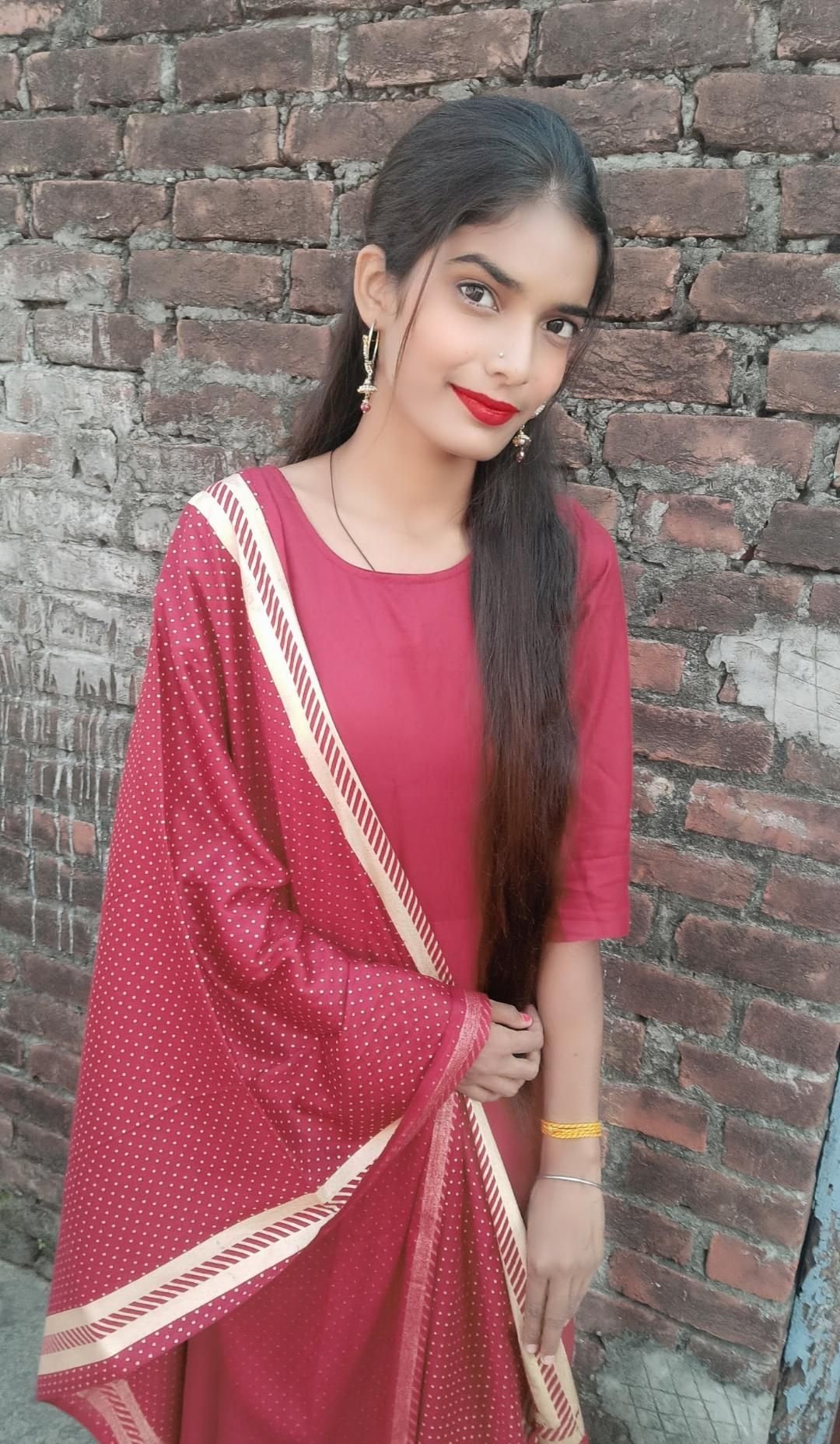 Priyanka smiling in a red outfit